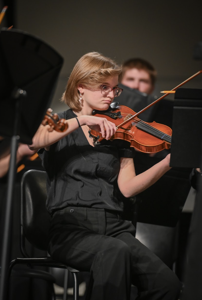 Samantha Gibbs (12) listens for her cue while playing "Mvt 1: Allegro." 